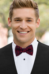 man wearing white shirt, floral apple red bow tie and solid black Expressions vest