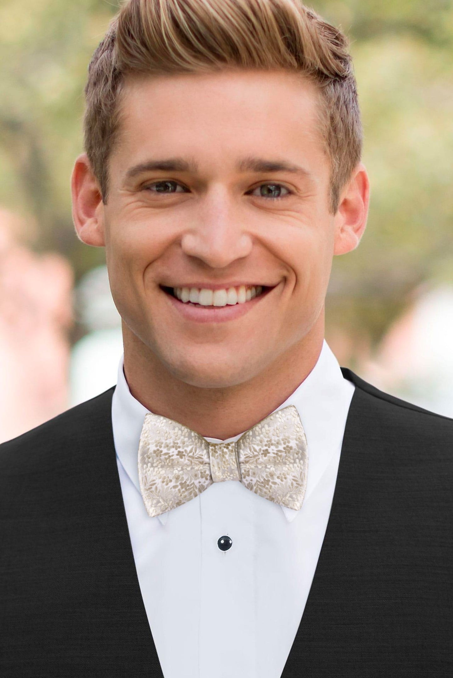 man wearing white shirt, floral champagne bow tie and solid black Expressions vest