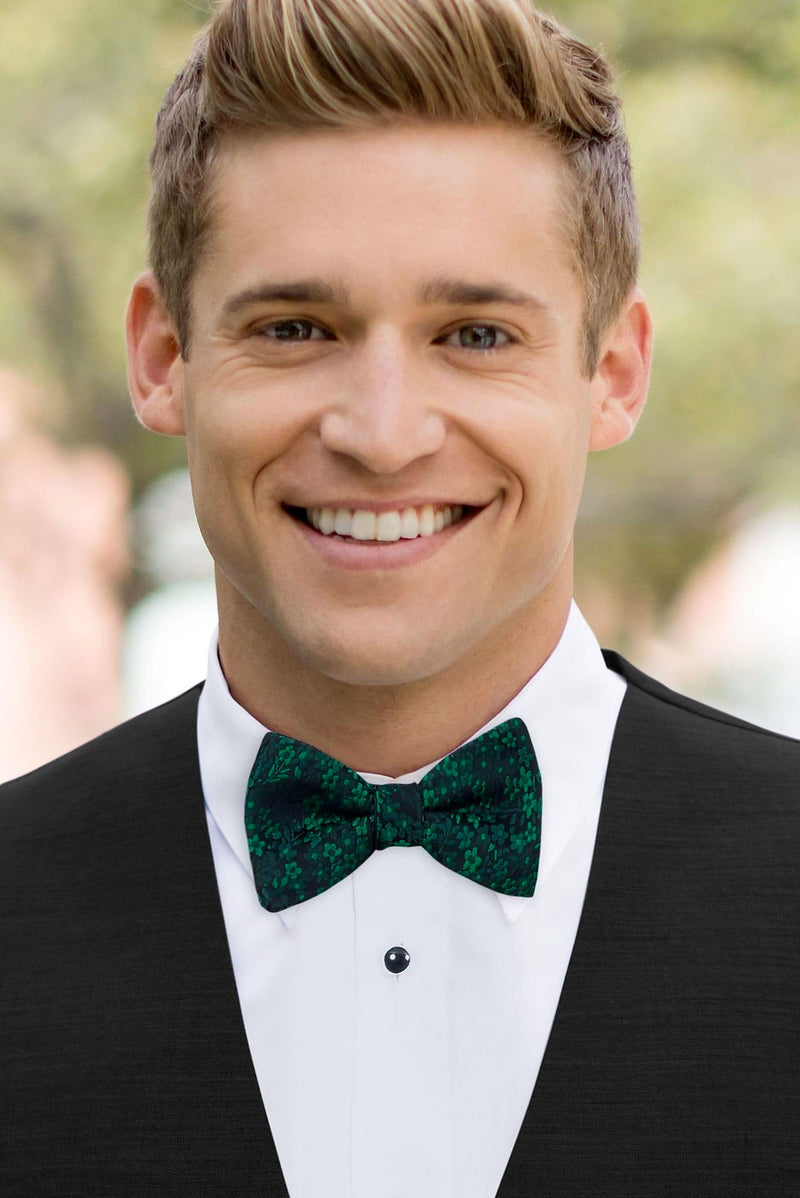 man wearing white shirt, floral emerald bow tie and solid black Expressions vest