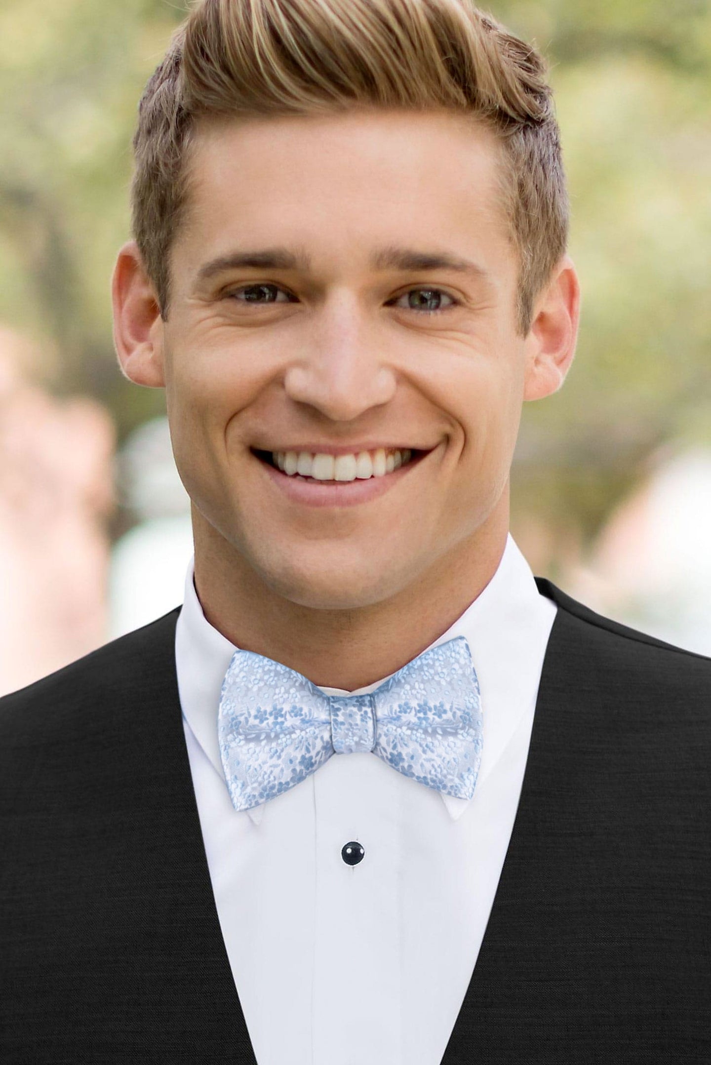 man wearing white shirt, floral lite blue bow tie and solid black Expressions vest