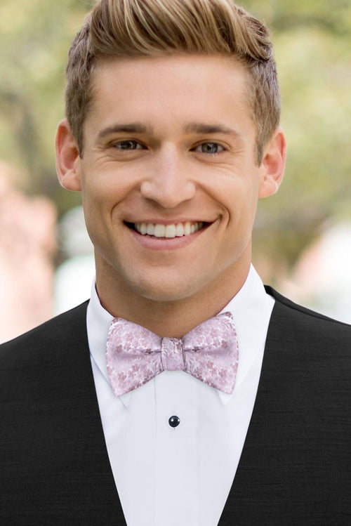 man wearing white shirt, floral mauve bow tie and solid black Expressions vest