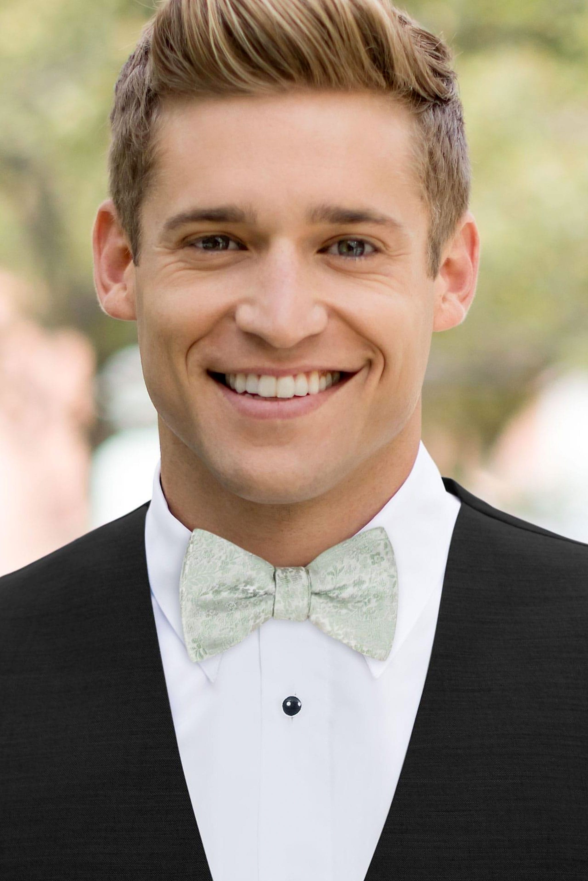 man wearing white shirt, floral sage bow tie and solid black Expressions vest