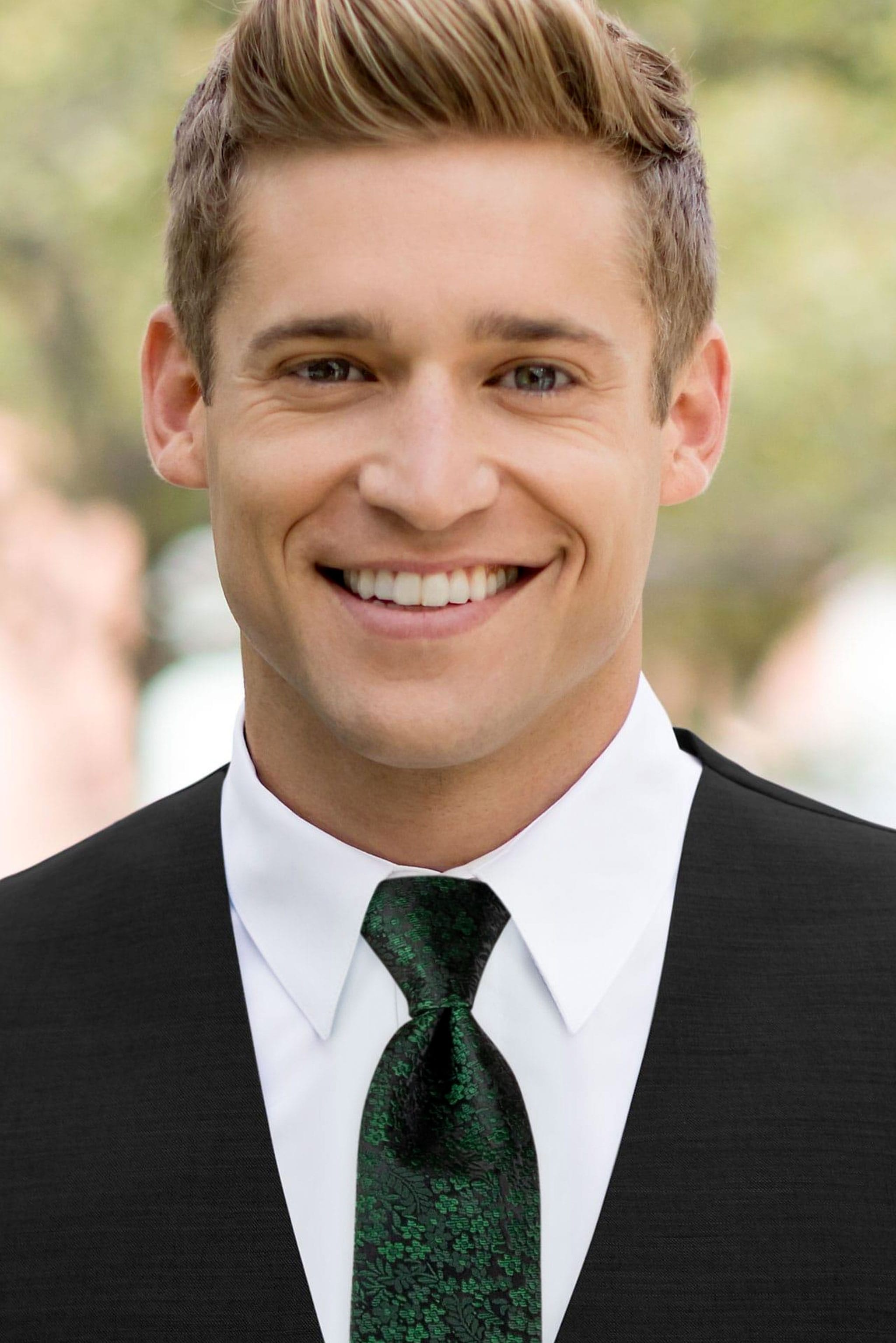 man wearing white shirt, floral dark green windsor tie and solid black Expressions vest