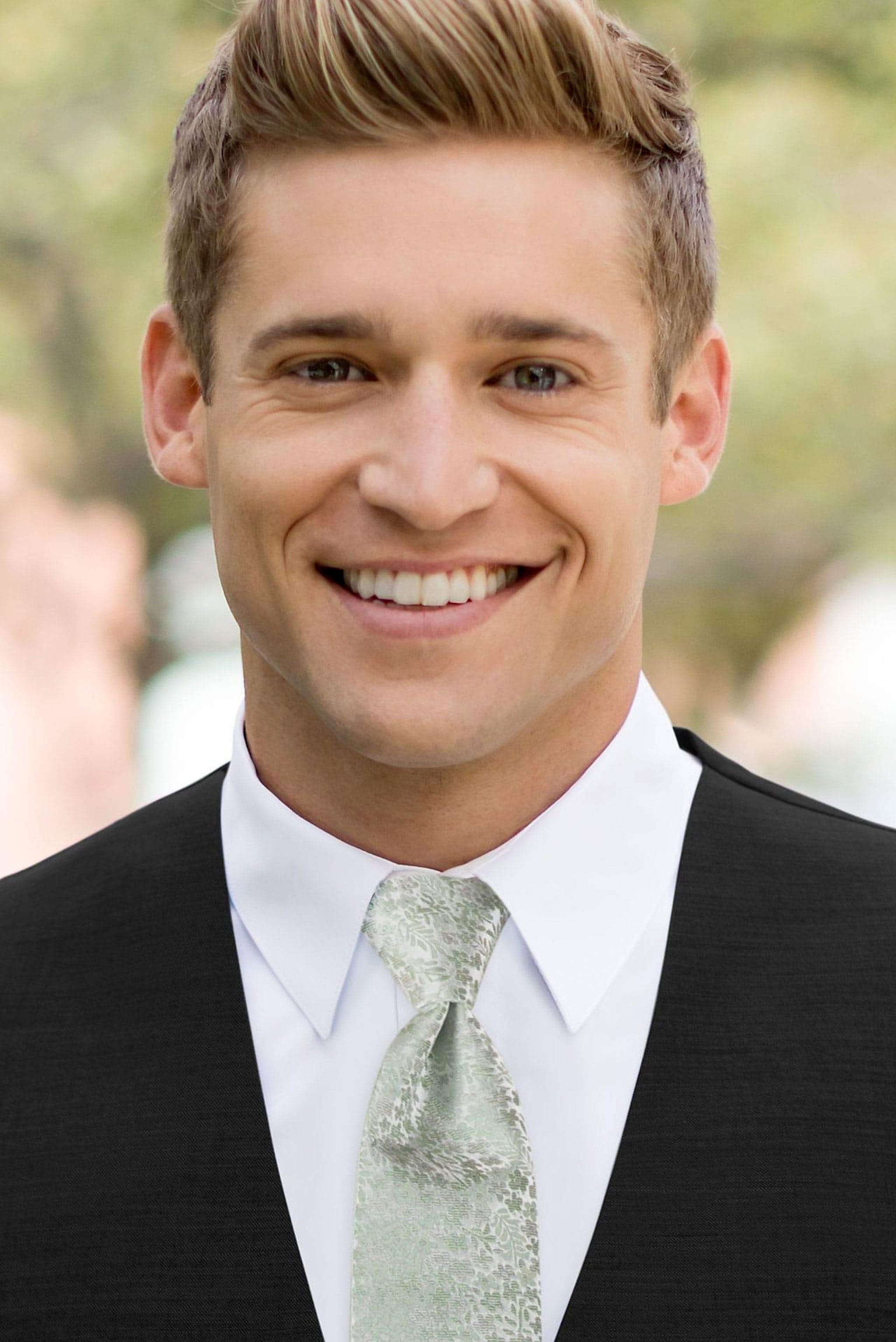 man wearing white shirt, floral sage windsor tie and solid black Expressions vest