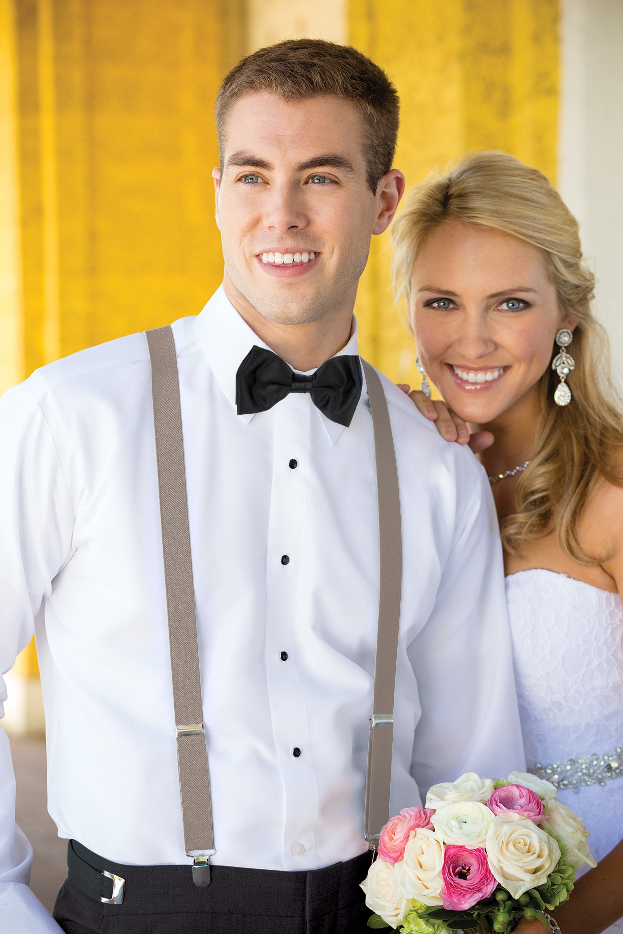 Man wearing white shirt, men’s sand clip-on suspenders, and coordinating blow tie