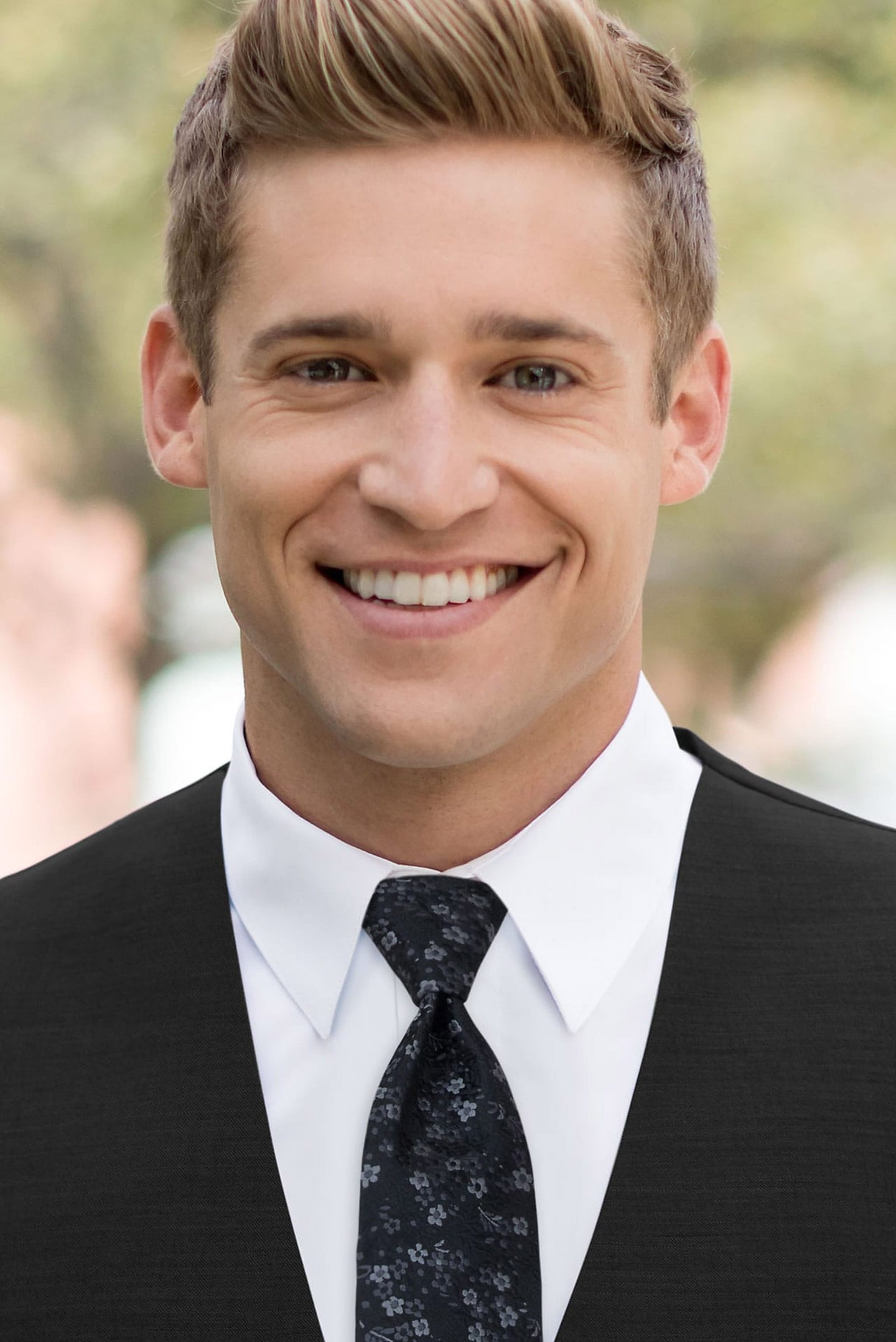 man wearing white shirt, floral black windsor tie and solid black Expressions vest